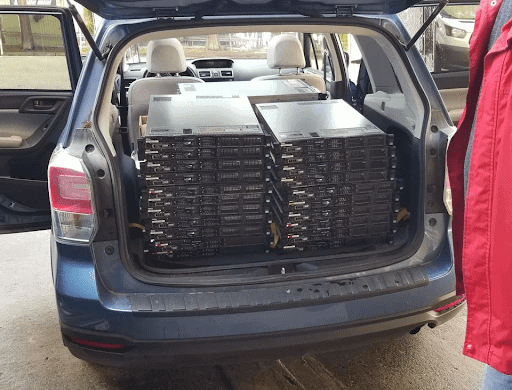 Computer servers stacked in the back of a car
